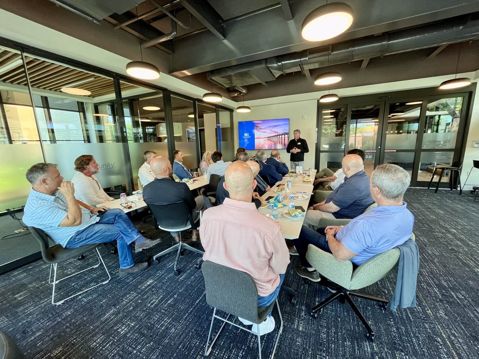 Nonprofit leaders around a boardroom table during a Mi Gulf Coast training session